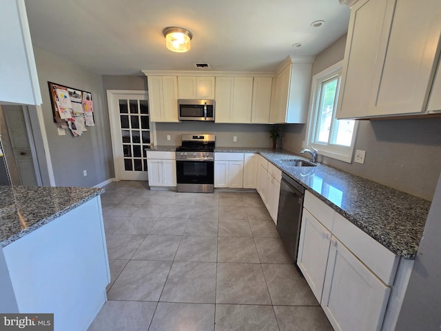 355 Leonard Ave, Hamilton, NJ 08619 - kitchen with appliances with stainless steel finishes, dark stone counters, white cabinets, and light tile patterned floors