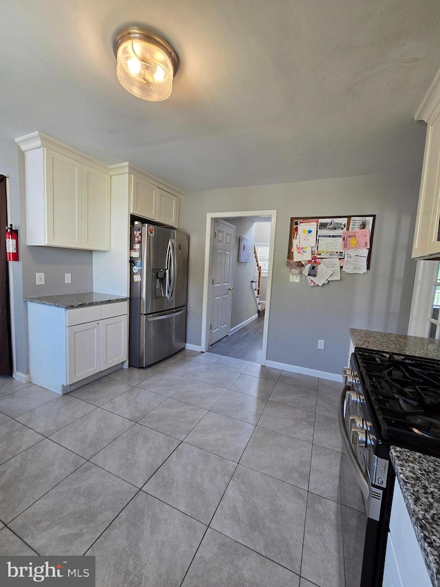 355 Leonard Ave, Hamilton, NJ 08619 - kitchen with stainless steel appliances, dark stone counters, and light tile patterned floors