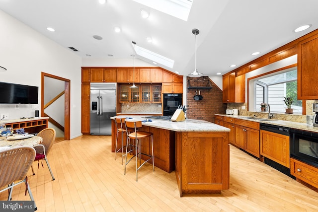 3 Vanderveer Dr, Lawrenceville, NJ 08648 - kitchen with black appliances, a skylight, decorative backsplash, a kitchen island, and a sink