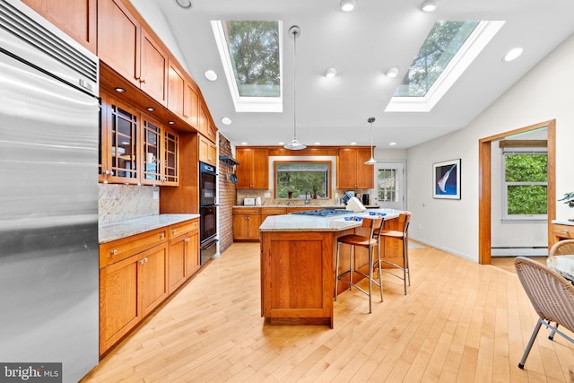 3 Vanderveer Dr, Lawrenceville, NJ 08648 - kitchen featuring built in refrigerator, a skylight, a baseboard radiator, a kitchen bar, and tasteful backsplash