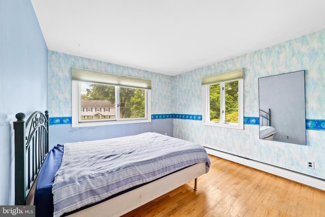 3 Vanderveer Dr, Lawrenceville, NJ 08648 - bedroom featuring wallpapered walls, a baseboard radiator, and hardwood / wood-style flooring
