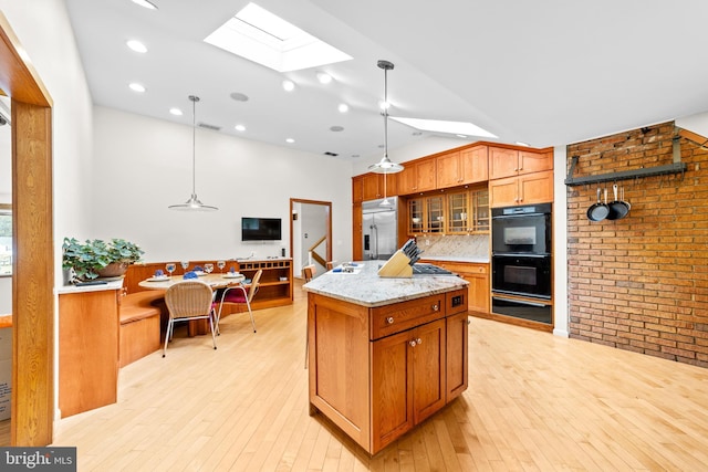 3 Vanderveer Dr, Lawrenceville, NJ 08648 - kitchen featuring stainless steel built in refrigerator, a skylight, light wood-style floors, glass insert cabinets, and light stone countertops