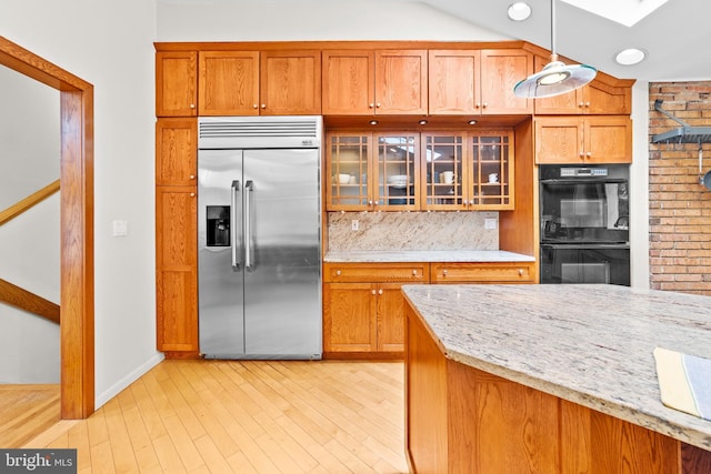 3 Vanderveer Dr, Lawrenceville, NJ 08648 - kitchen with built in fridge, a skylight, glass insert cabinets, light stone countertops, and tasteful backsplash