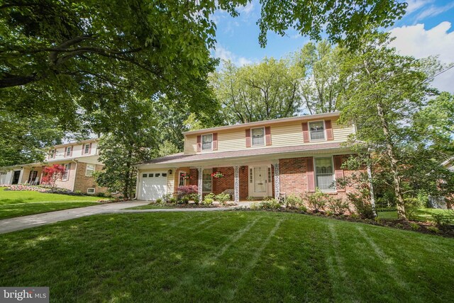 11816 Prestwick Rd, Potomac, MD 20854 - traditional-style house featuring driveway, a garage, and a front yard