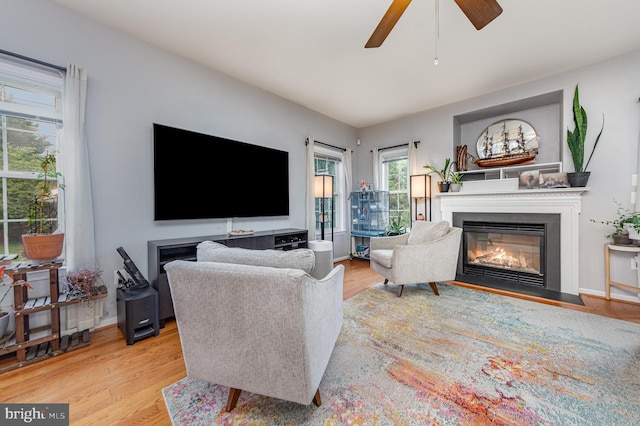 18 Basket Ct, Stafford, VA 22554 - living area featuring a fireplace with flush hearth, light wood-type flooring, and a ceiling fan