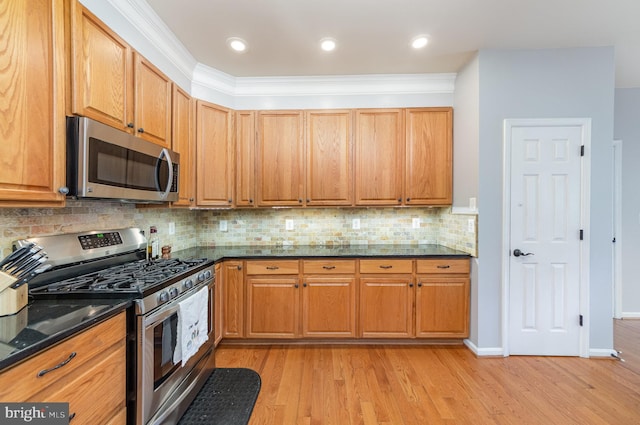 18 Basket Ct, Stafford, VA 22554 - kitchen featuring appliances with stainless steel finishes, light wood finished floors, decorative backsplash, dark stone counters, and brown cabinets
