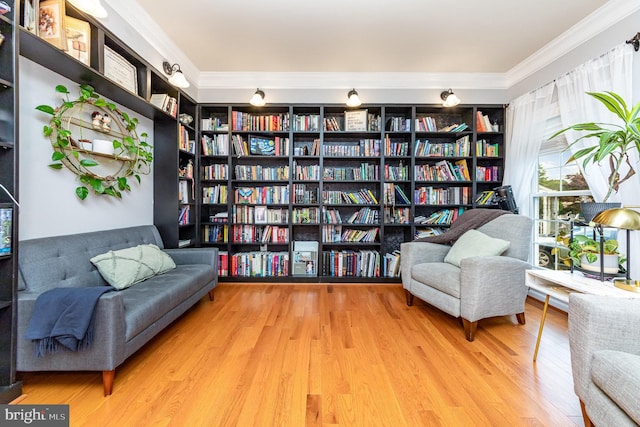 18 Basket Ct, Stafford, VA 22554 - sitting room with wall of books, ornamental molding, and wood finished floors