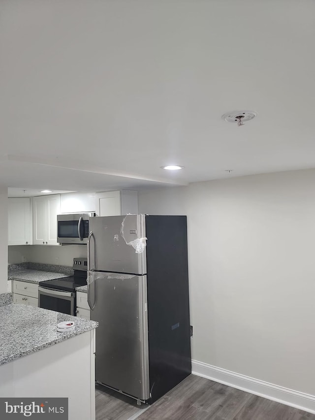113 15th St SE, Washington, DC 20003 - kitchen with stainless steel appliances, dark wood-style flooring, white cabinetry, light stone counters, and recessed lighting