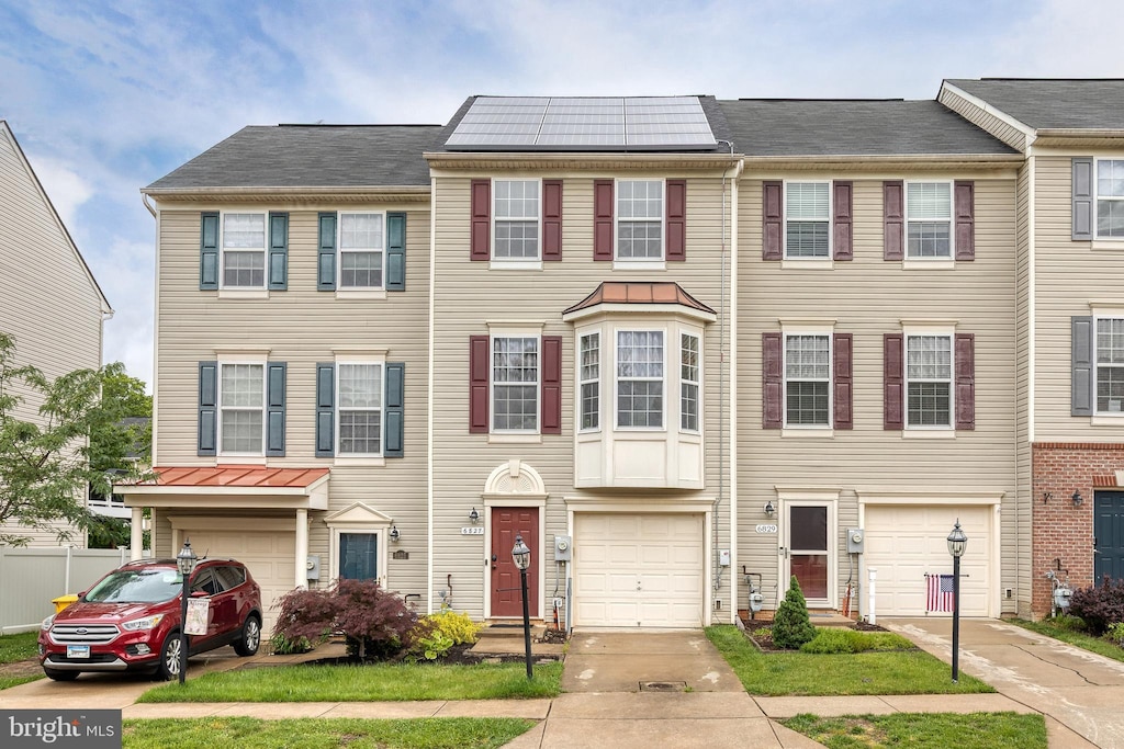 6827 Warfield St, Glen Burnie, MD 21060 - townhome / multi-family property with an attached garage and driveway