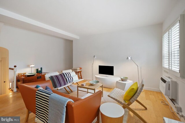 3503 Martha Custis Dr, Alexandria, VA 22302 - living area with light wood finished floors, a wall unit AC, and baseboards