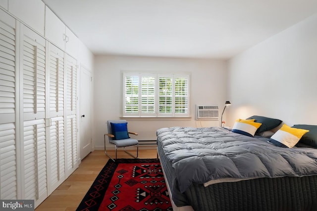 3503 Martha Custis Dr, Alexandria, VA 22302 - bedroom with light wood finished floors, an AC wall unit, and baseboard heating