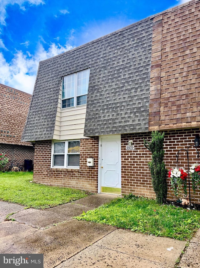 9939 Wingtip Rd, Philadelphia, PA 19115 - view of front of house with brick siding, roof with shingles, and mansard roof