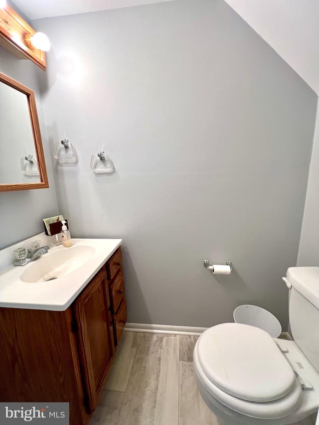 9939 Wingtip Rd, Philadelphia, PA 19115 - half bathroom featuring toilet, vanity, wood finished floors, and baseboards