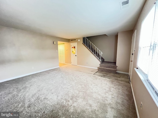 9939 Wingtip Rd, Philadelphia, PA 19115 - unfurnished living room featuring stairs, carpet flooring, and baseboards