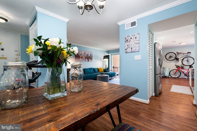 7708 Hanover Pkwy Unit 303, Greenbelt, MD 20770 - dining area with wood finished floors, ornamental molding, a chandelier, and baseboards