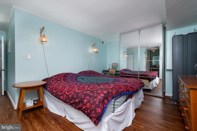 7708 Hanover Pkwy Unit 303, Greenbelt, MD 20770 - bedroom with ornamental molding, wood finished floors, and baseboards