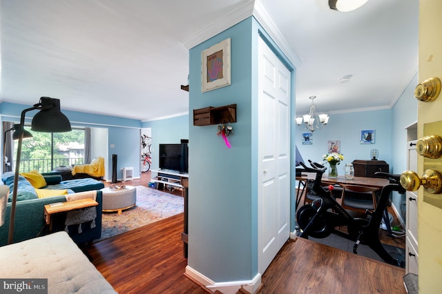 7708 Hanover Pkwy Unit 303, Greenbelt, MD 20770 - living area with dark wood-style floors, ornamental molding, baseboards, and a chandelier