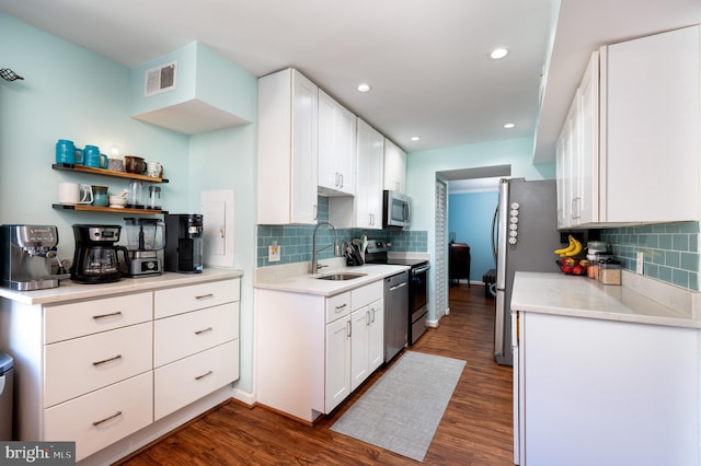 7708 Hanover Pkwy Unit 303, Greenbelt, MD 20770 - kitchen featuring a sink, stainless steel appliances, backsplash, dark wood-style flooring, and recessed lighting