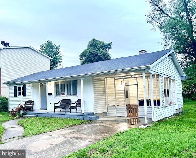 126 Cherry St, Dover, DE 19904 - view of front of house featuring a porch, roof with shingles, a front lawn, and concrete driveway