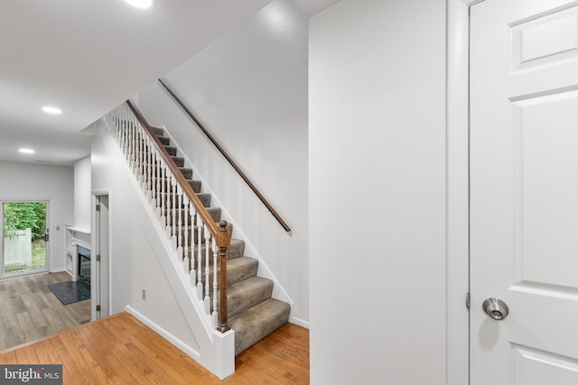 24 Beechtree Ln, Mountville, PA 17554 - stairway featuring wood finished floors, baseboards, a premium fireplace, and recessed lighting