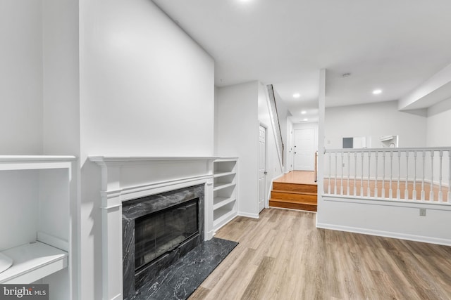 24 Beechtree Ln, Mountville, PA 17554 - unfurnished living room with wood finished floors, a fireplace, recessed lighting, and stairway