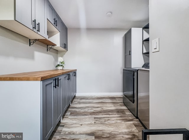 4920 Ed Mcclain Rd, Monrovia, MD 21770 - kitchen featuring open shelves, separate washer and dryer, butcher block countertops, light wood-type flooring, and gray cabinetry