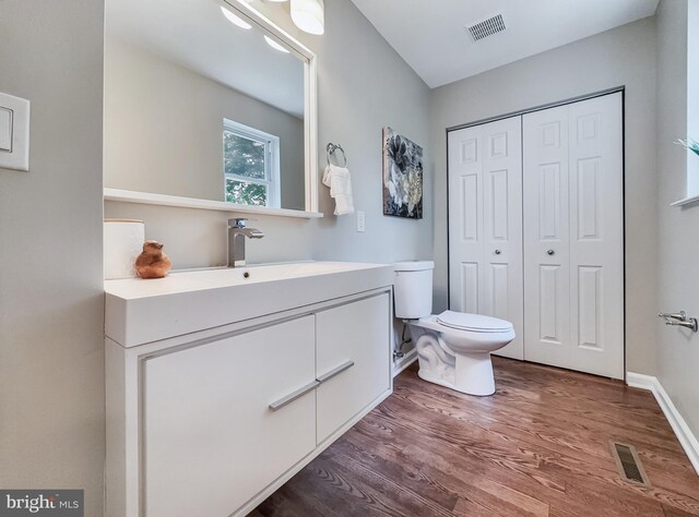 4920 Ed Mcclain Rd, Monrovia, MD 21770 - bathroom with wood finished floors, toilet, a closet, and vanity