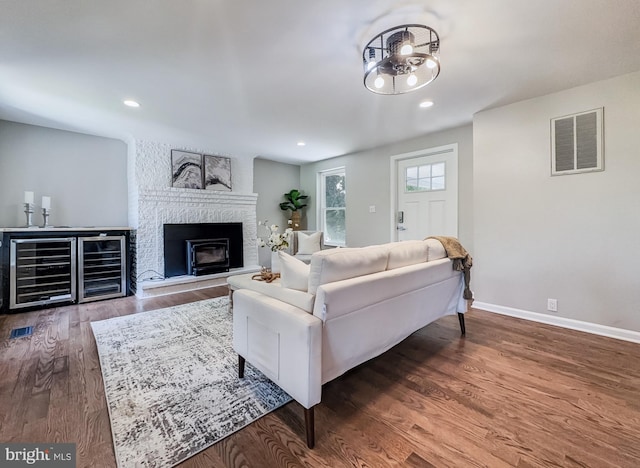 4920 Ed Mcclain Rd, Monrovia, MD 21770 - living area featuring wood finished floors, baseboards, a brick fireplace, and recessed lighting