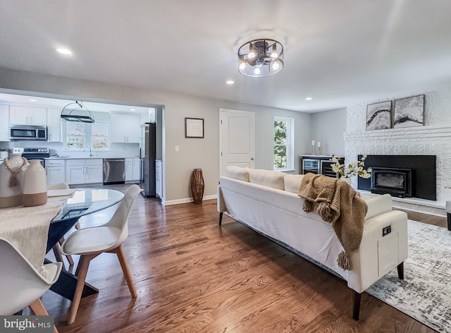 4920 Ed Mcclain Rd, Monrovia, MD 21770 - living area with wood finished floors, a chandelier, recessed lighting, baseboards, and a fireplace