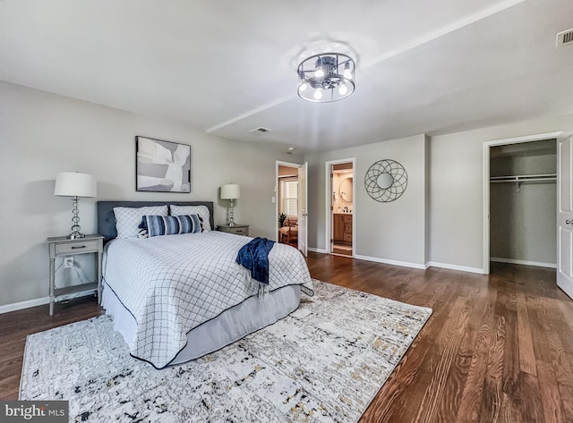 4920 Ed Mcclain Rd, Monrovia, MD 21770 - bedroom featuring wood finished floors, baseboards, a chandelier, a closet, and a walk in closet