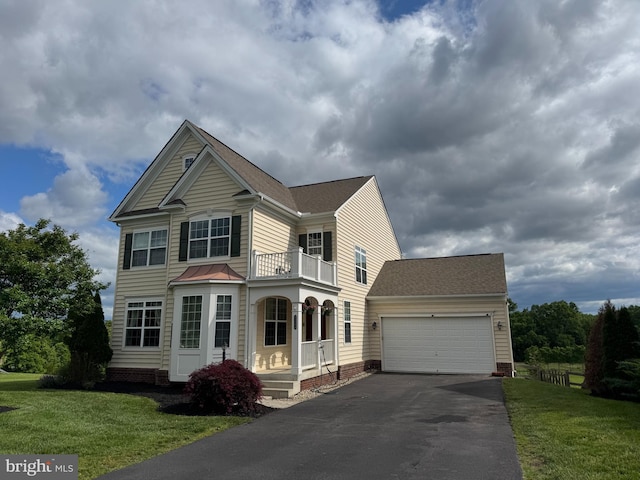 43268 Heavenly Cir, Leesburg, VA 20176 - traditional home featuring a balcony, asphalt driveway, an attached garage, a front yard, and roof with shingles