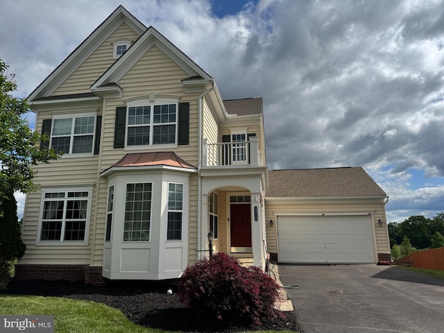43268 Heavenly Cir, Leesburg, VA 20176 - traditional-style house featuring driveway, an attached garage, a balcony, and roof with shingles