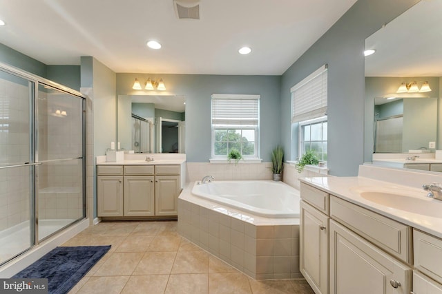 43268 Heavenly Cir, Leesburg, VA 20176 - bathroom with two vanities, a stall shower, a garden tub, tile patterned floors, and recessed lighting