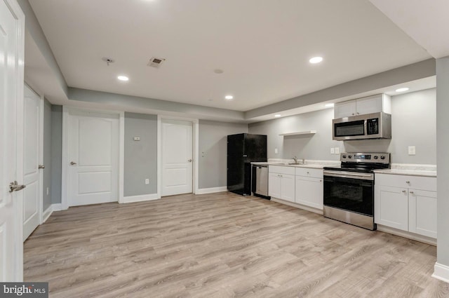 43268 Heavenly Cir, Leesburg, VA 20176 - kitchen featuring appliances with stainless steel finishes, light wood finished floors, white cabinets, light countertops, and recessed lighting