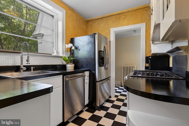 60 Old Eagle School Rd, Wayne, PA 19087 - kitchen featuring appliances with stainless steel finishes, tile patterned floors, radiator heating unit, dark countertops, and white cabinets