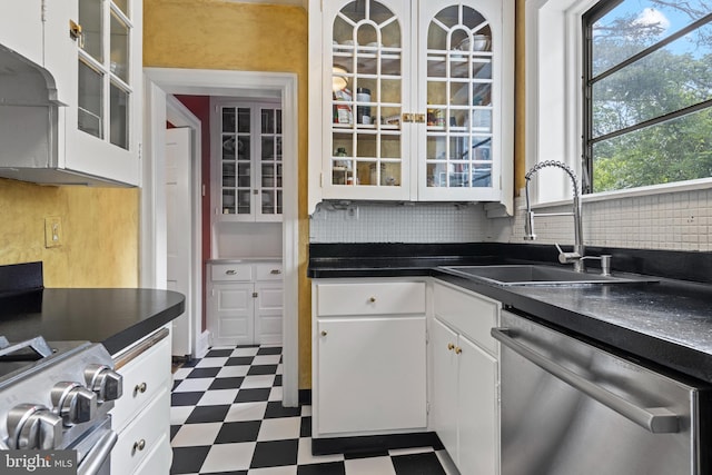 60 Old Eagle School Rd, Wayne, PA 19087 - kitchen with appliances with stainless steel finishes, dark floors, a sink, white cabinets, and tasteful backsplash
