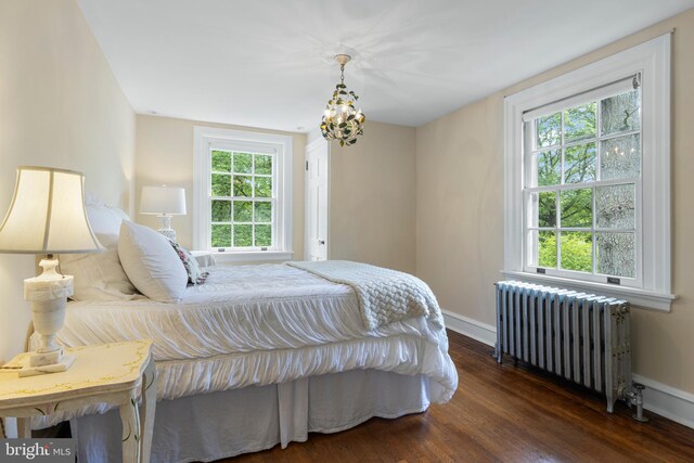 60 Old Eagle School Rd, Wayne, PA 19087 - bedroom with radiator, multiple windows, wood finished floors, and a chandelier