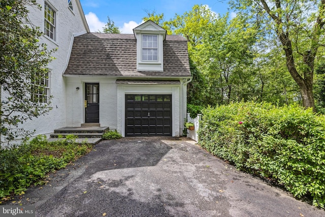 60 Old Eagle School Rd, Wayne, PA 19087 - view of front facade featuring roof with shingles, driveway, stucco siding, and an attached garage