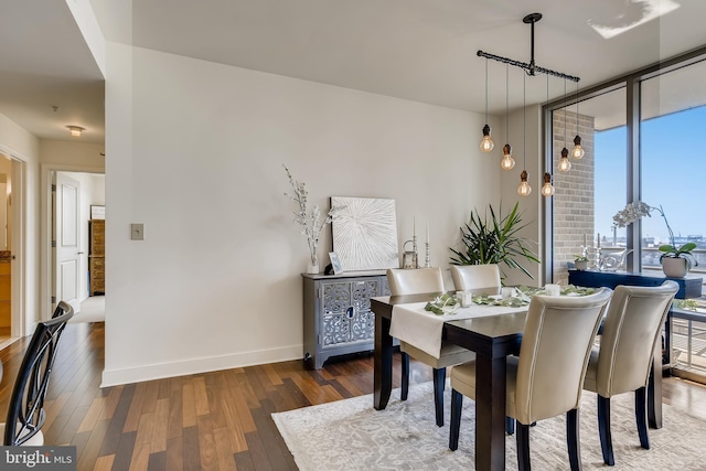 675 President St Unit 2105, Baltimore, MD 21202 - dining area featuring wood finished floors, baseboards, and a wall of windows