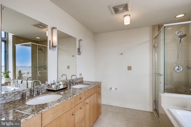 675 President St Unit 2105, Baltimore, MD 21202 - bathroom with double vanity, a stall shower, a bath, tile patterned floors, and baseboards