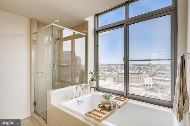 675 President St Unit 2105, Baltimore, MD 21202 - full bath with a garden tub, a stall shower, tile patterned flooring, and a city view