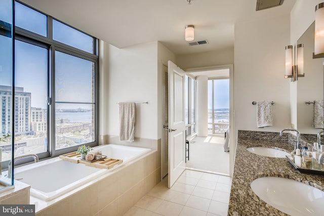 675 President St Unit 2105, Baltimore, MD 21202 - full bathroom with healthy amount of natural light, a garden tub, double vanity, and tile patterned flooring