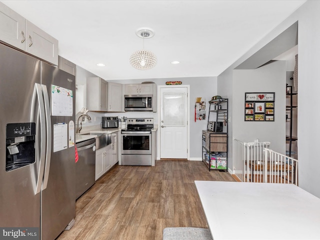 42 Bucher John Rd, Union Bridge, MD 21791 - kitchen with appliances with stainless steel finishes, wood finished floors, a sink, light countertops, and a chandelier