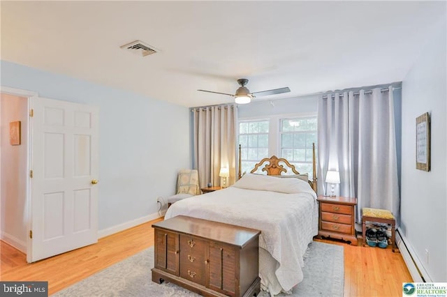 113 S Fairview St, Macungie, PA 18062 - bedroom featuring a baseboard heating unit, wood finished floors, and baseboards
