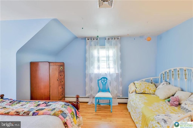 113 S Fairview St, Macungie, PA 18062 - bedroom with wood finished floors, baseboard heating, a baseboard radiator, and vaulted ceiling