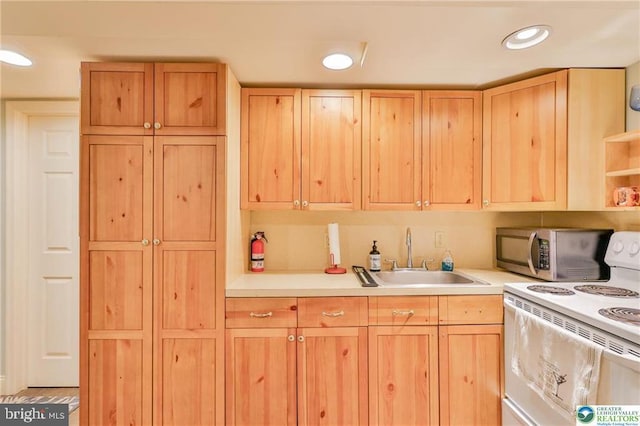 113 S Fairview St, Macungie, PA 18062 - kitchen with white range with electric cooktop, a sink, stainless steel microwave, light brown cabinetry, and light countertops