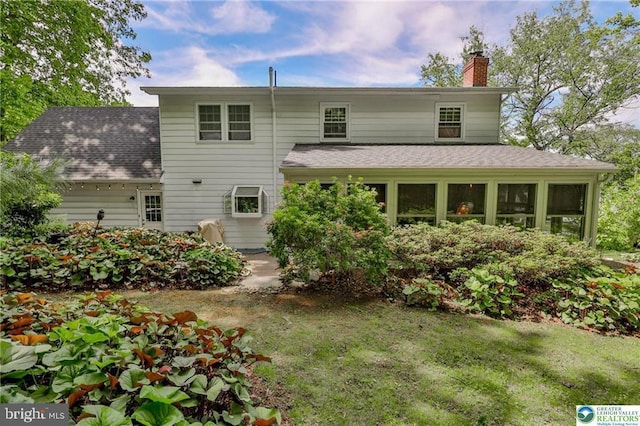 113 S Fairview St, Macungie, PA 18062 - back of house with a chimney, roof with shingles, and a lawn