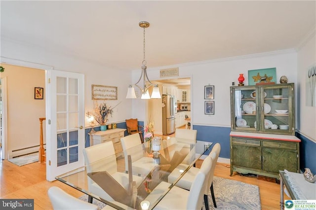113 S Fairview St, Macungie, PA 18062 - dining area with a baseboard heating unit, wood finished floors, and crown molding
