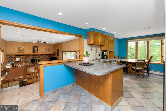 130 Bellmawr Ave, Haddon Heights, NJ 08035 - kitchen featuring a ceiling fan, light countertops, a brick fireplace, a peninsula, and recessed lighting