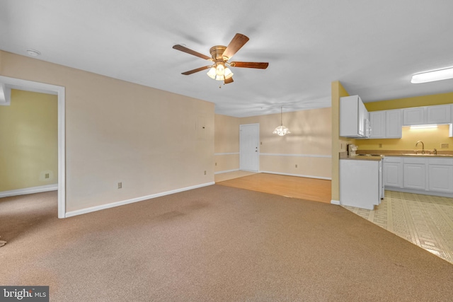 4078 Rose Bud Ct, Edinburg, VA 22824 - unfurnished living room featuring a sink, light colored carpet, a ceiling fan, and baseboards